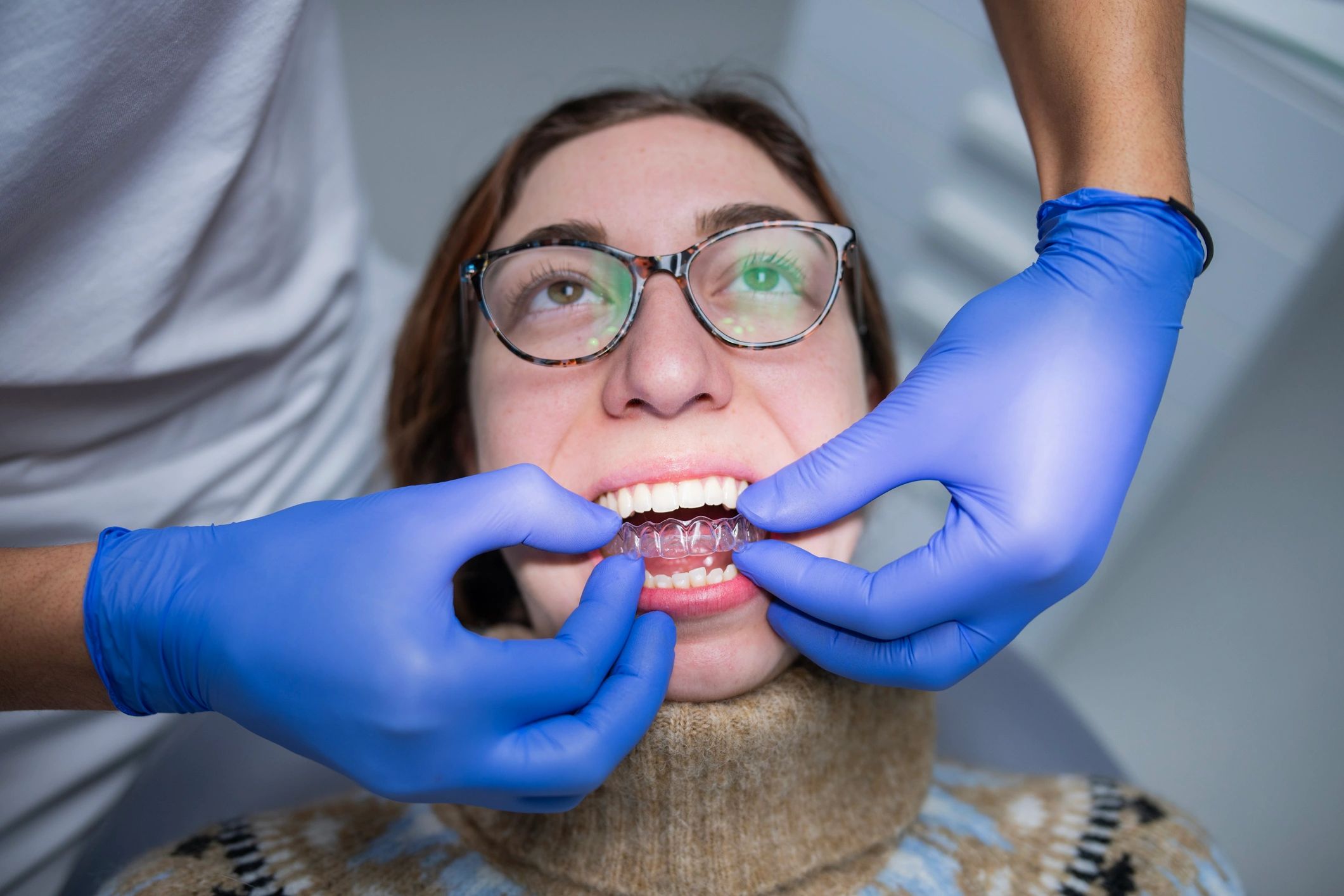 Dentist fitting a clear aligner